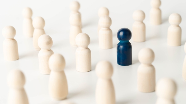 Symbolic image of rare diseases: a blue wooden figure in a group of white wooden figures Symbolic image of rare diseases: a blue wooden figure in a group of white wooden figures